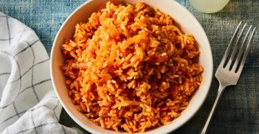 The rice dish known as jollof originates in West Africa. The dish is typically prepared in a pot with long-grain rice, spices, tomatoes, onions, meat, and vegetables. Both ingredients and methods of preparation are subject to regional variation.